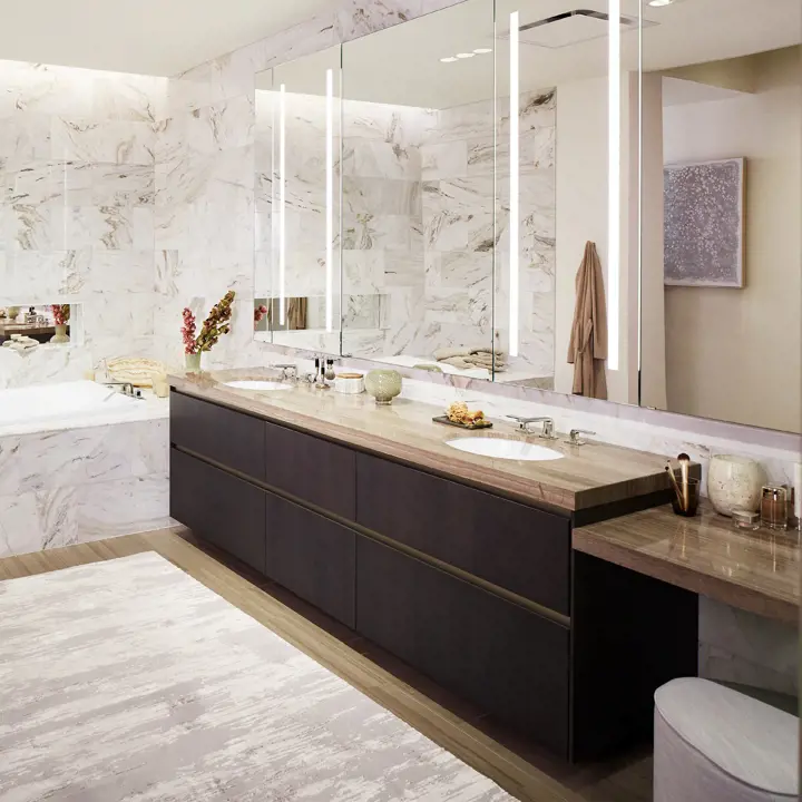 Modern bathroom vanity with double sinks, large mirrors, marble walls, and integrated lighting.