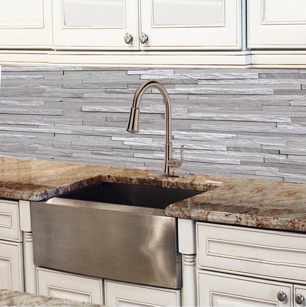 Bath and Bronze stainless farmhouse sink with brushed faucet, granite counters, and stone backsplash.